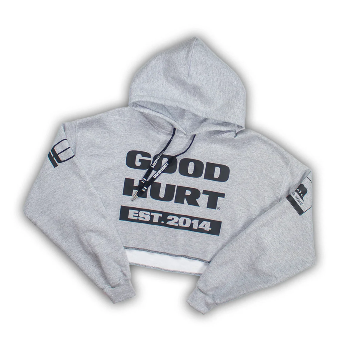 A light gray cropped hoodie with 'GOOD HURT EST. 2014' printed in black on the front, featuring black drawstrings and sleeve patches, shown on a white background.