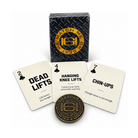 A deck of motivational weightlifting playing cards and matching metal tokens on a clean white background. The set includes a black diamond-textured box with a gold circular logo, three cream-colored cards labeled Dead Lifts, Hanging Knee Lifts, and Chin-Ups, and a round bronze-toned challenge coin.